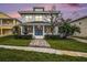 Charming two-story home features a welcoming front yard with a fountain and beautiful landscaping at 5426 Venetian Ne Blvd, St Petersburg, FL 33703