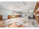 Spacious garage with unfinished walls, shelving, and tile debris on the floor at 5426 Venetian Ne Blvd, St Petersburg, FL 33703