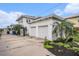 Exterior view of a detached two car garage surrounded by landscaping and a driveway at 5426 Venetian Ne Blvd, St Petersburg, FL 33703