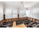 Bright living room in mid-renovation with exposed wall framing and abundant natural light from large windows at 5426 Venetian Ne Blvd, St Petersburg, FL 33703