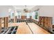 Open-concept living room in mid-renovation with exposed wall framing, plywood flooring, and modern lighting at 5426 Venetian Ne Blvd, St Petersburg, FL 33703
