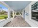 Inviting front porch with stone flooring and a view of the charming fountain in the yard at 5426 Venetian Ne Blvd, St Petersburg, FL 33703