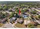 Aerial view of the home in its neighborhood, showing its position surrounded by trees and nearby houses at 5507 Bluejay Ln, Tampa, FL 33625