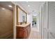 Hall bathroom with a double sink vanity, ornate mirror, and a doorless marble shower with built-in seat at 5507 Bluejay Ln, Tampa, FL 33625