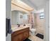 Bathroom featuring a vanity, toilet, and shower-tub combination with natural light from the window at 5507 Bluejay Ln, Tampa, FL 33625