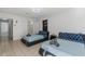 Bedroom featuring tile floors, two beds, and a closet for storage at 5507 Bluejay Ln, Tampa, FL 33625
