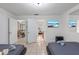 Bright bedroom with tile flooring and two beds adjacent to the dining room at 5507 Bluejay Ln, Tampa, FL 33625