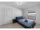 Modern bedroom with tiled floors, large closet, and ample natural light at 5507 Bluejay Ln, Tampa, FL 33625
