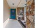 Inviting entrance with a vibrant blue front door, stone accents, and a covered porch at 5507 Bluejay Ln, Tampa, FL 33625