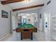 Game room showcasing a pool table, tile floors, and access to multiple rooms in the home at 5507 Bluejay Ln, Tampa, FL 33625