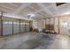 Spacious garage with storage, an electric garage door, and a utility door leading outside at 5507 Bluejay Ln, Tampa, FL 33625