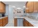 Bright kitchen boasts granite countertops and stainless steel dishwasher at 5507 Bluejay Ln, Tampa, FL 33625