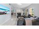 Bright living room featuring tile floors, a fireplace, and large windows for natural light at 5507 Bluejay Ln, Tampa, FL 33625
