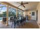 Screened-in patio with dining and lounge furniture, ceiling fan, and a poolside view at 5507 Bluejay Ln, Tampa, FL 33625