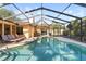 A pristine screened-in pool is framed by a well-kept deck and landscaping, creating a serene outdoor retreat at 5507 Bluejay Ln, Tampa, FL 33625