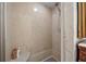 Step-in shower with smooth stone-look walls and a built-in corner seat, alongside toiletry storage at 5507 Bluejay Ln, Tampa, FL 33625