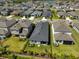 Aerial view showcases backyard with covered patio and lush landscaping in a residential neighborhood at 5523 Del Coronado Dr, Apollo Beach, FL 33572