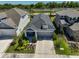 Aerial view of well-maintained home with manicured lawn, landscape beds and inviting front porch at 5523 Del Coronado Dr, Apollo Beach, FL 33572