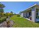 Landscaped backyard with covered patio and lush lawn, perfect for outdoor enjoyment at 5523 Del Coronado Dr, Apollo Beach, FL 33572