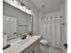 Bright bathroom featuring a gray vanity, modern lighting, and a shower with white tiling at 5523 Del Coronado Dr, Apollo Beach, FL 33572