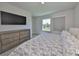 Bright bedroom featuring a large window, a dresser and neutral walls at 5523 Del Coronado Dr, Apollo Beach, FL 33572