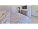 Spacious bedroom featuring a queen bed, mounted TV, plank floors and closet space at 5523 Del Coronado Dr, Apollo Beach, FL 33572
