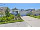 Attractive home with a manicured lawn, vibrant flowerbeds, and a spacious driveway leading to the garage at 5523 Del Coronado Dr, Apollo Beach, FL 33572