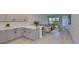 Open kitchen showcasing light gray cabinets, quartz countertops and an open floor plan into the living room at 5523 Del Coronado Dr, Apollo Beach, FL 33572