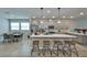 Eat-in kitchen featuring a large island with bar seating, gray cabinets and stainless steel appliances at 5523 Del Coronado Dr, Apollo Beach, FL 33572