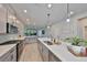 Well-lit kitchen features modern appliances, stylish countertops, and a large island with seating at 5523 Del Coronado Dr, Apollo Beach, FL 33572
