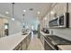 Modern kitchen featuring an island, stainless steel appliances, and gray cabinets with quartz countertops at 5523 Del Coronado Dr, Apollo Beach, FL 33572