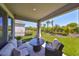Comfortable covered patio with seating and lush backyard view for relaxing or entertaining at 5523 Del Coronado Dr, Apollo Beach, FL 33572