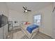 Bright bedroom featuring a ceiling fan, and a white vanity and mirror set near the window at 5745 Skytop Dr, Lithia, FL 33547