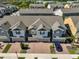 Aerial view of townhomes featuring brick driveways, attached garages, and manicured front yards at 5745 Skytop Dr, Lithia, FL 33547