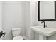 Powder room featuring a pedestal sink, modern faucet, and a toilet at 6605 N Nebraska Ave # 30, Tampa, FL 33604