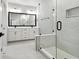 Bathroom features a glass enclosed shower, double sink vanity, and light tile flooring at 6605 N Nebraska Ave # 30, Tampa, FL 33604