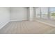 Bright bedroom featuring neutral carpet, white trim, and three windows providing plenty of natural light at 6605 N Nebraska Ave # 30, Tampa, FL 33604