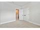 Bedroom with neutral carpet, white trim, and a double door closet for storage at 6605 N Nebraska Ave # 30, Tampa, FL 33604