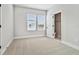 Bedroom featuring two windows for natural light and a doorway leading to an attached bathroom at 6605 N Nebraska Ave # 30, Tampa, FL 33604