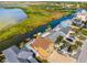 Waterfront home with a private dock surrounded by lush greenery and serene water views at 6633 Driftwood Dr, Hudson, FL 34667