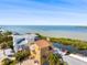 Waterfront multi-story home with a balcony, surrounded by lush greenery and stunning water views at 6633 Driftwood Dr, Hudson, FL 34667