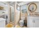 Bathroom boasts a tiled shower, modern vanity, and a window for natural light at 6633 Driftwood Dr, Hudson, FL 34667