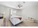 Cozy bedroom features hardwood floors, neutral paint and a ceiling fan at 6633 Driftwood Dr, Hudson, FL 34667