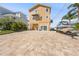 Charming two-story coastal home with boat on trailer and paved driveway at 6633 Driftwood Dr, Hudson, FL 34667