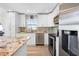Kitchen features white cabinets, granite countertops, stainless steel appliances, and a breakfast bar at 6633 Driftwood Dr, Hudson, FL 34667