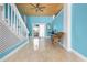 Living room with glossy tile floors, blue walls, and stairs going to second level at 6633 Driftwood Dr, Hudson, FL 34667