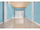 Bright living room boasts a wooden ceiling, tiled floors, and neutral blue walls at 6633 Driftwood Dr, Hudson, FL 34667