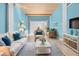 Comfortable coastal-themed living room features glossy tile floors, wood ceiling and blue walls at 6633 Driftwood Dr, Hudson, FL 34667