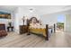 Elegant main bedroom with hardwood floors, decorative lamps, and balcony access at 6633 Driftwood Dr, Hudson, FL 34667