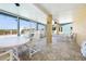 Enclosed patio with tile flooring, ceiling fan, and outdoor seating at 6633 Driftwood Dr, Hudson, FL 34667
